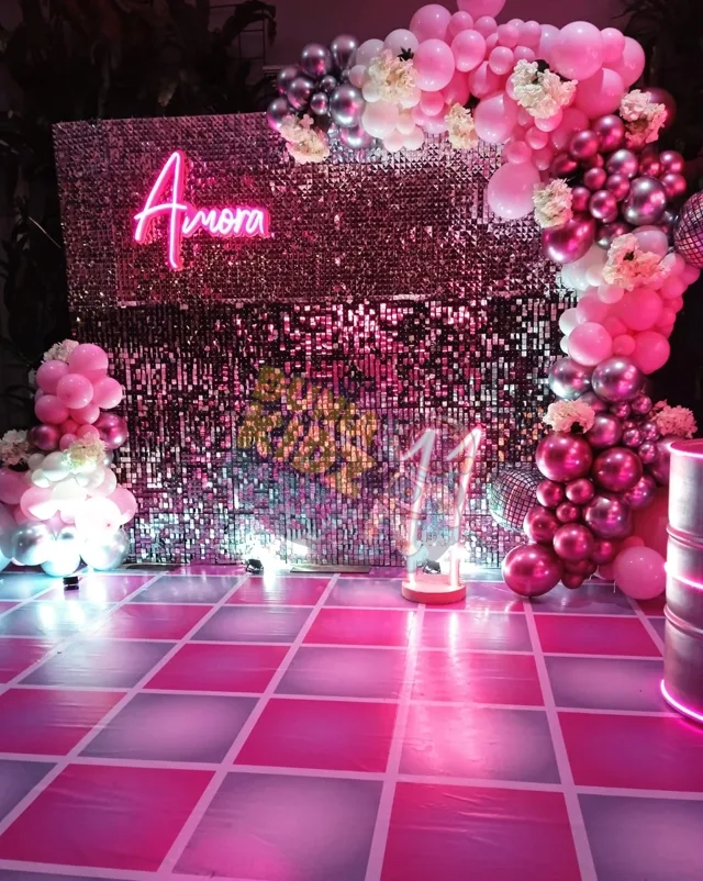 Pink sequin backdrop with balloon decoration at a kids birthday party